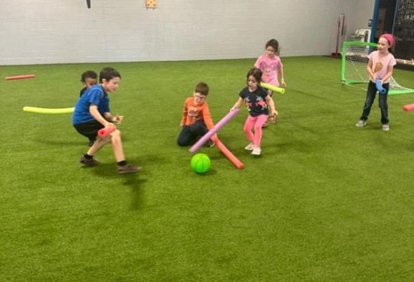Physical Development Center Kids playing Soccer with Pool Noodles