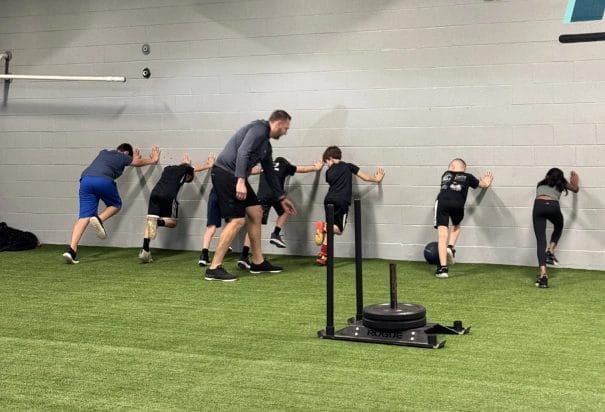 Physical Development Center Kids Pushing Wall