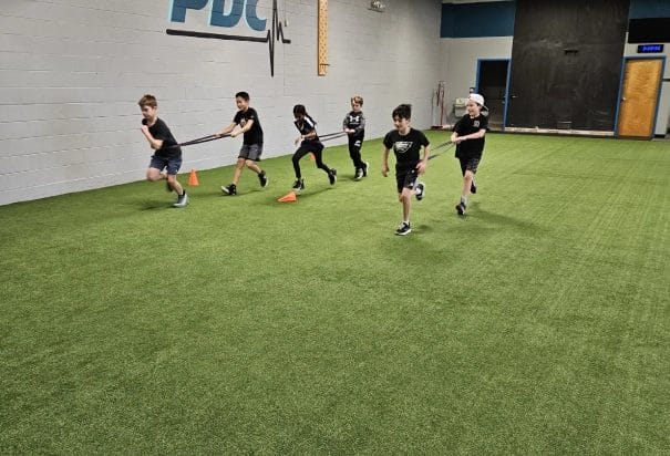 Physical Development Center Kids Running with Resistance Bands